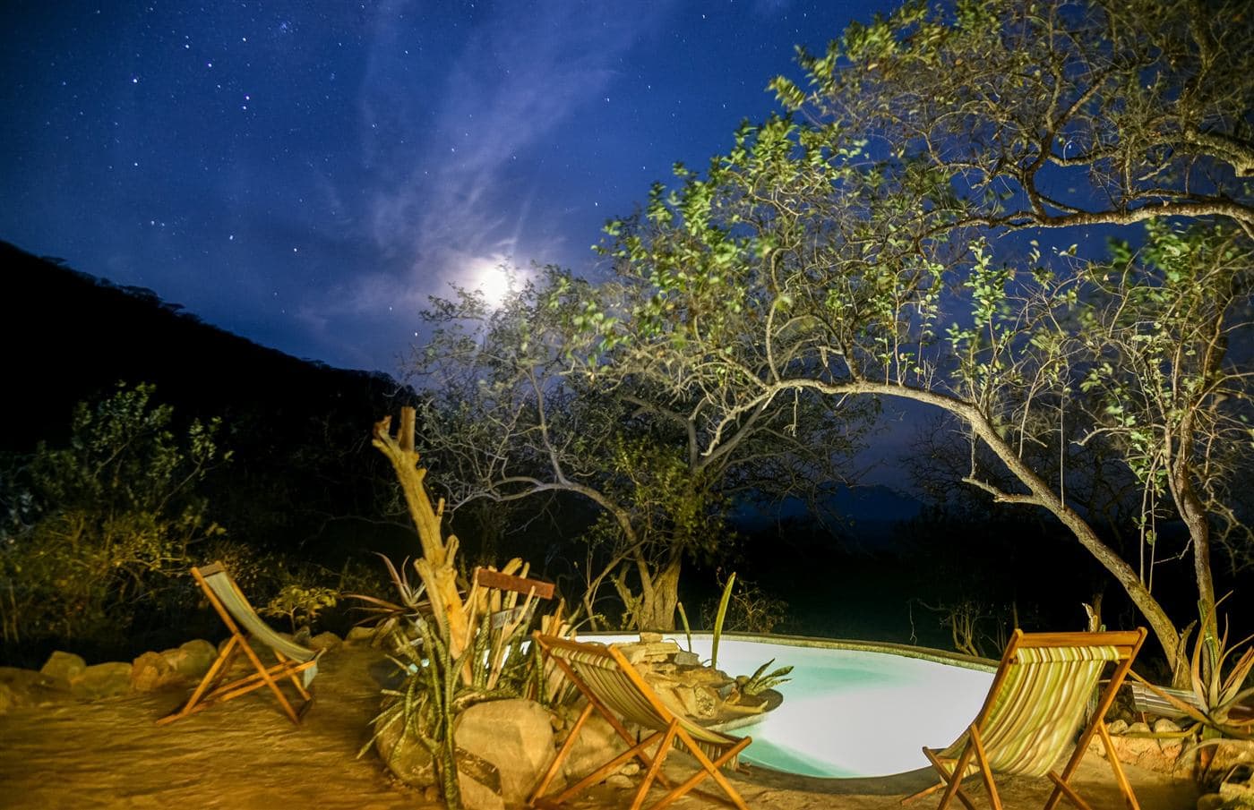 The camp pool under a starry, moonlit sky